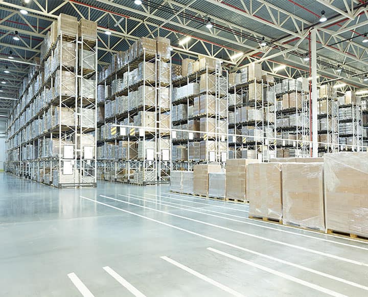 big warehouse with lines of shelfs full of packages