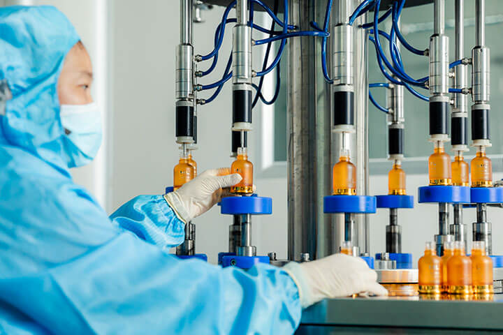 a worker is placing a bottle on the production line