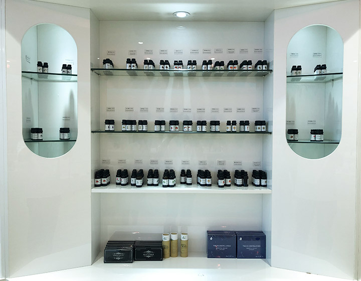 small bottles of essential oil samples being displayed on a shelf