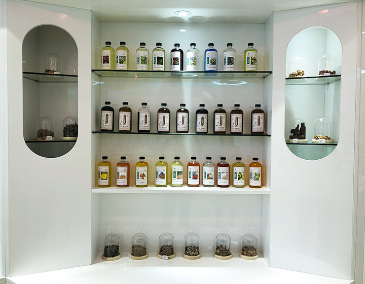 big bottles of essential oil samples being displayed on a shelf